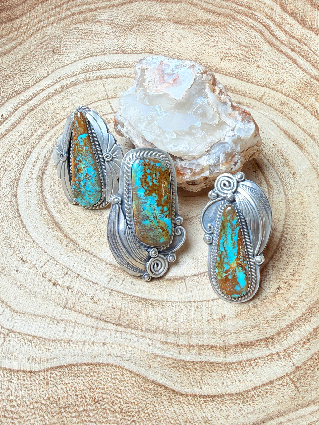 Silver earrings with turquoise stones on a wooden surface