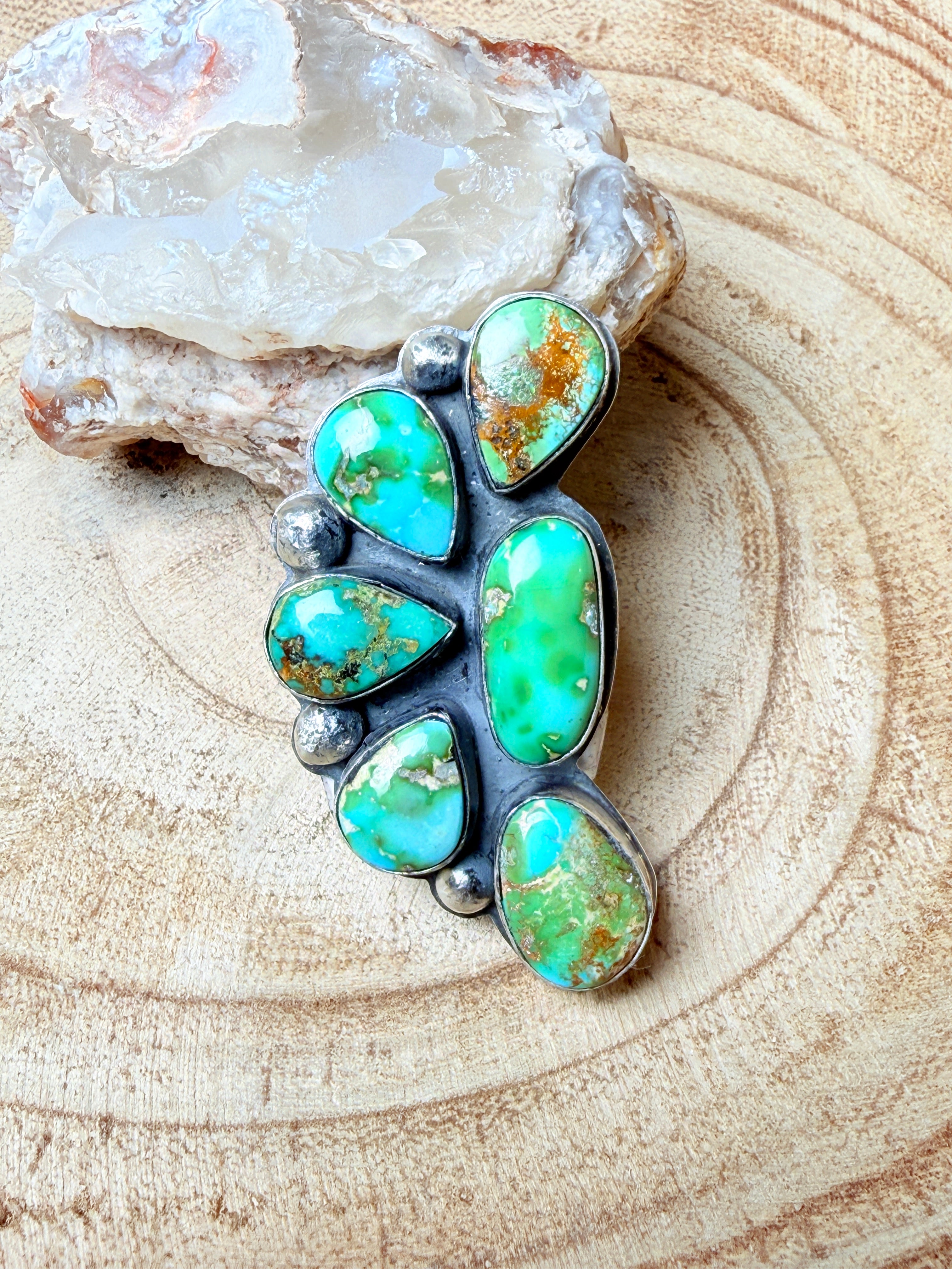 Turquoise stone ring on a textured beige surface
