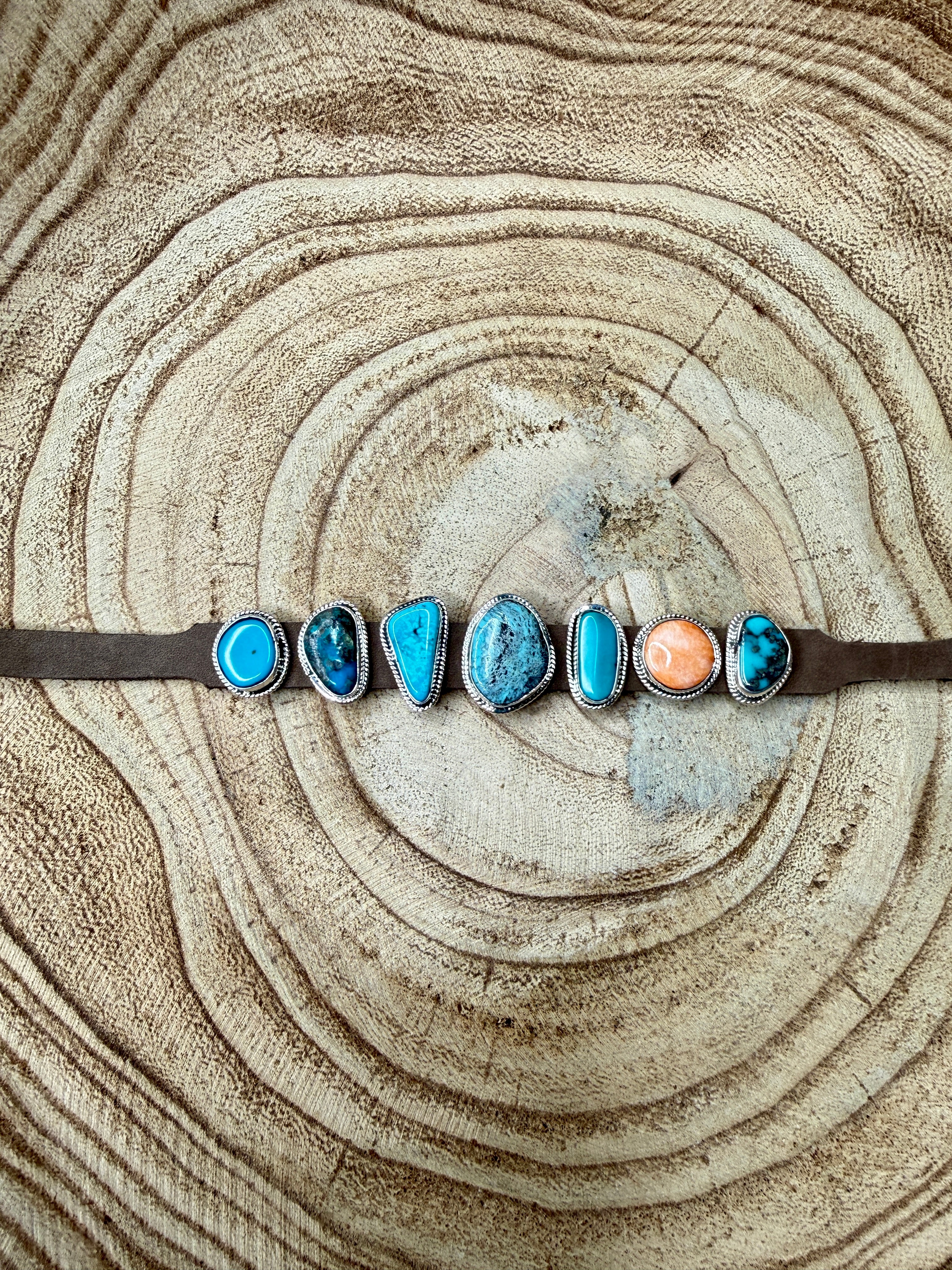 Bracelet with turquoise and coral stones on a wooden surface