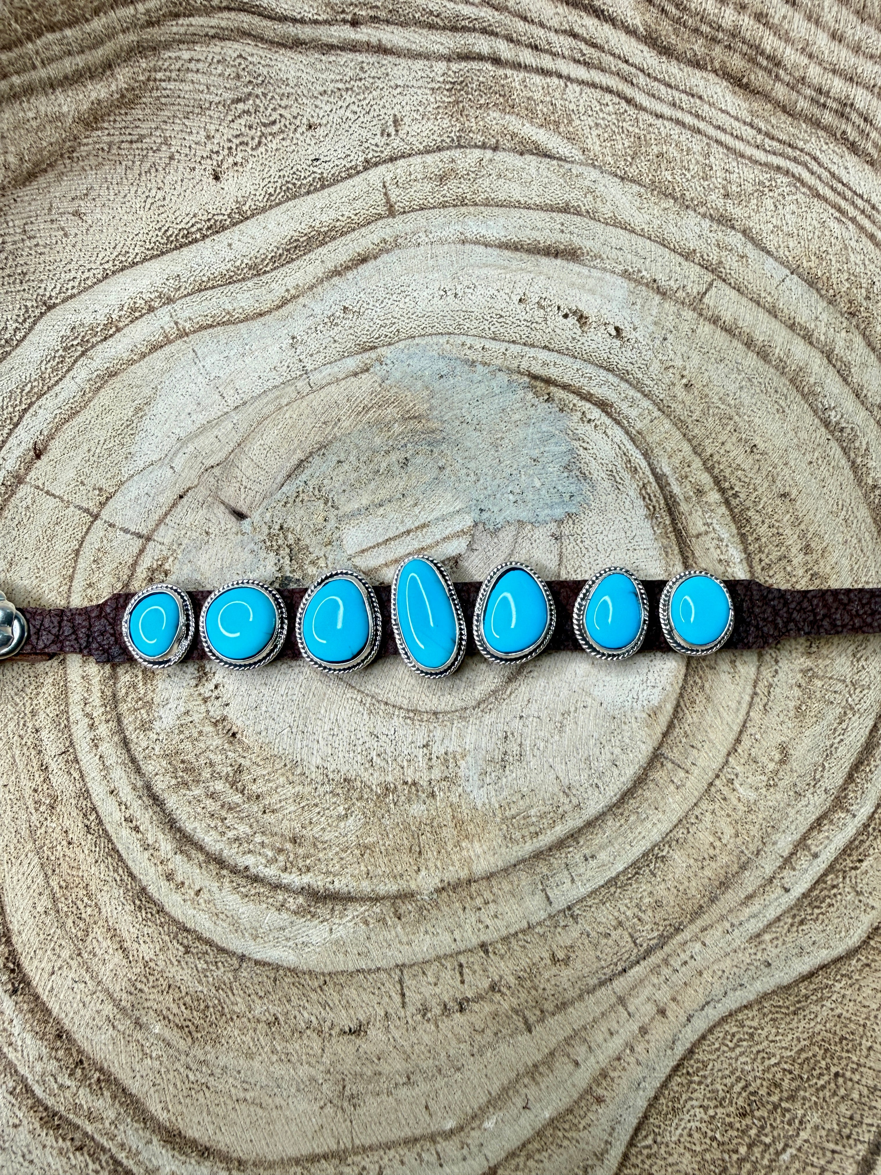 Bracelet with turquoise stones on a wooden surface