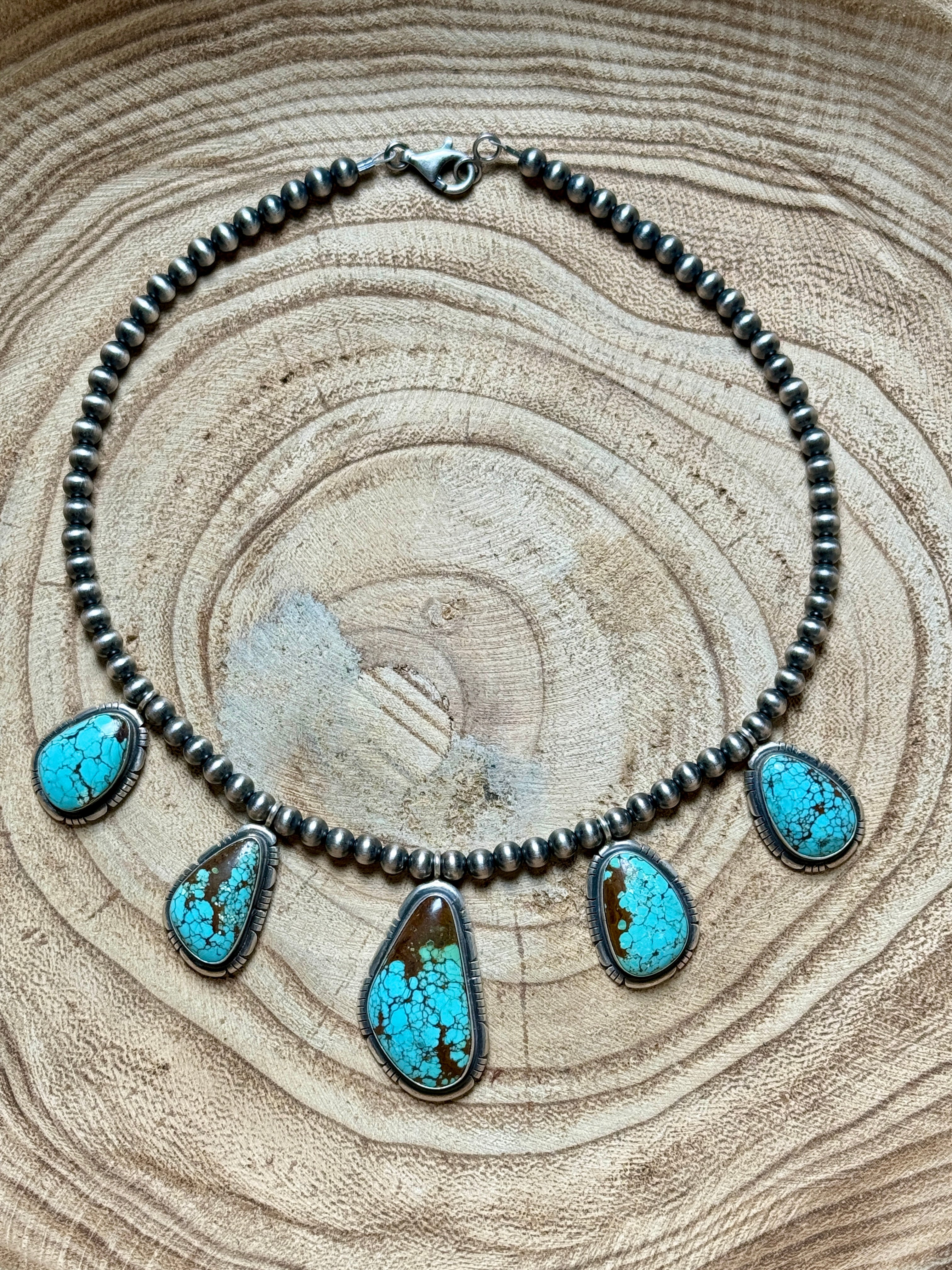 Necklace with turquoise stones on a wooden surface