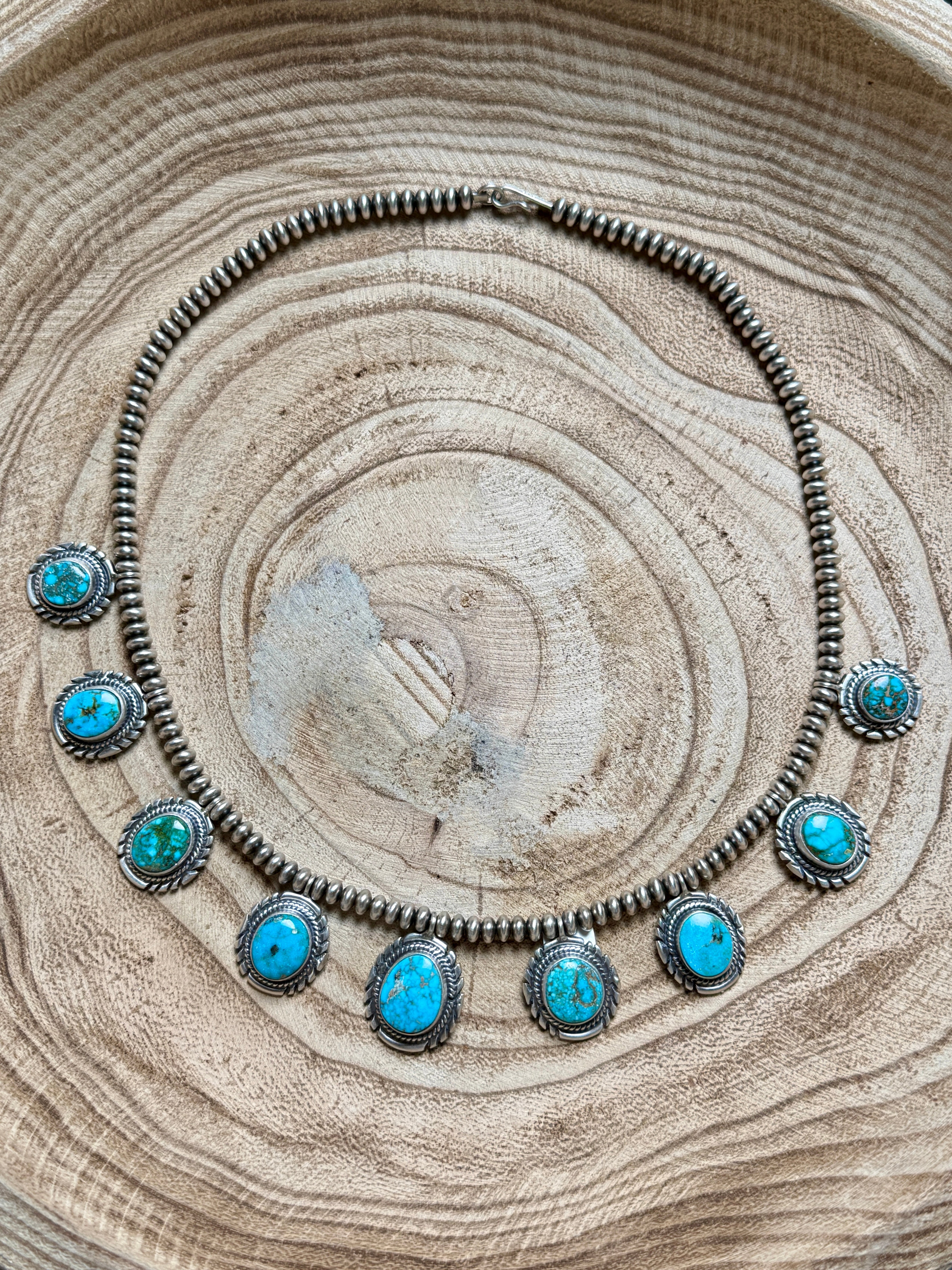 Necklace with turquoise stones on a wooden surface