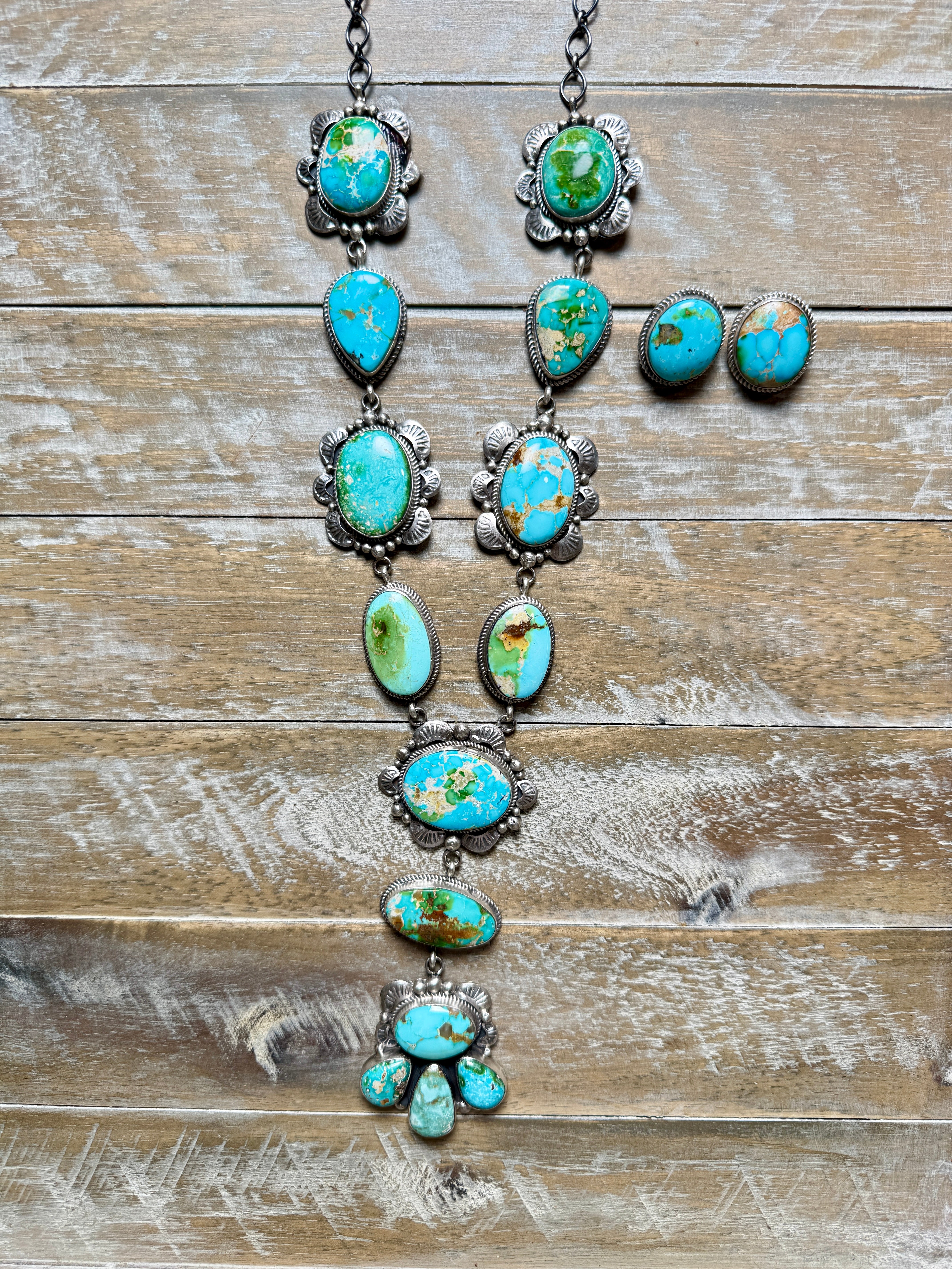 Turquoise necklace and earrings on a wooden surface