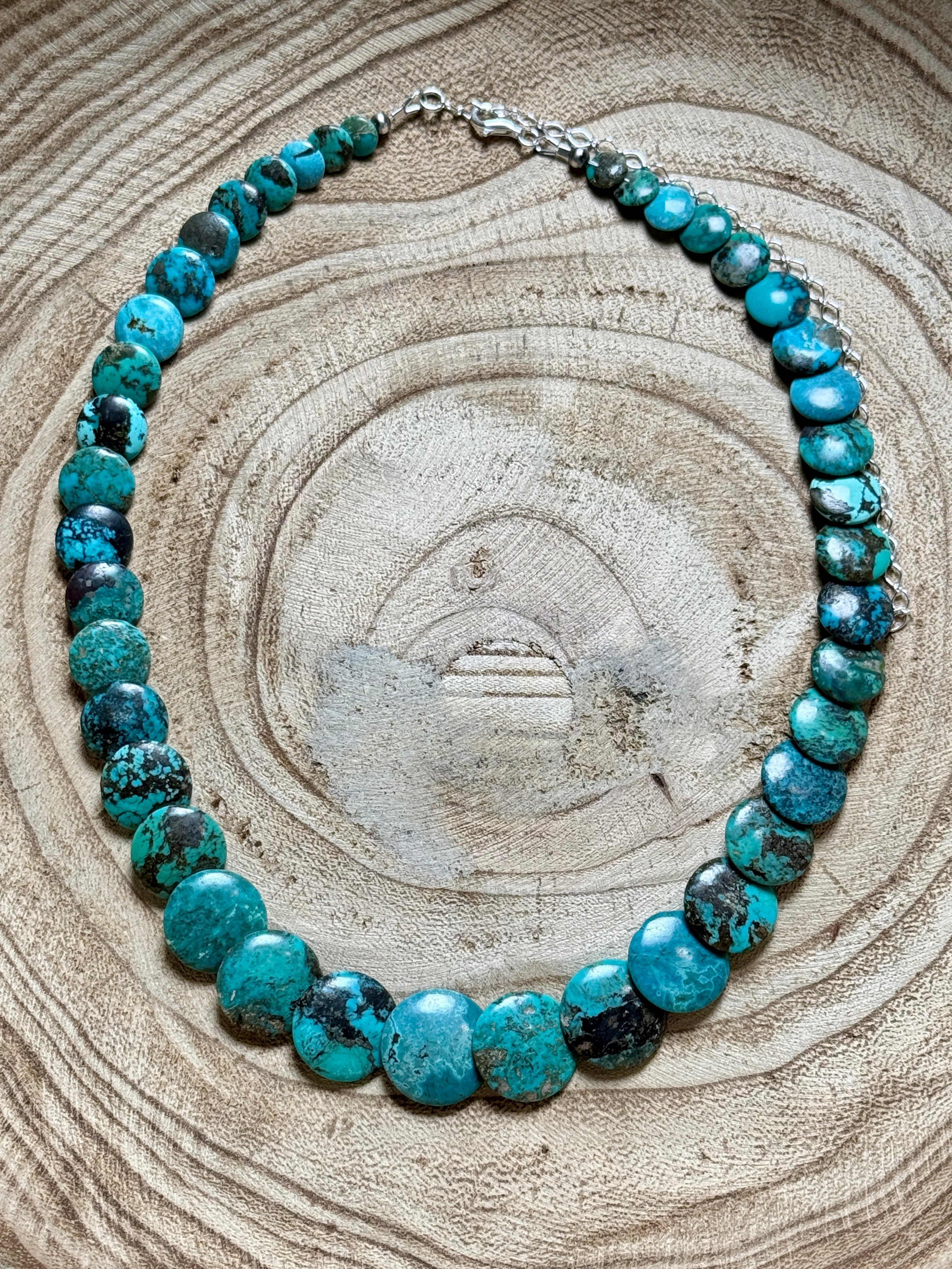 Turquoise beaded necklace on a wooden surface