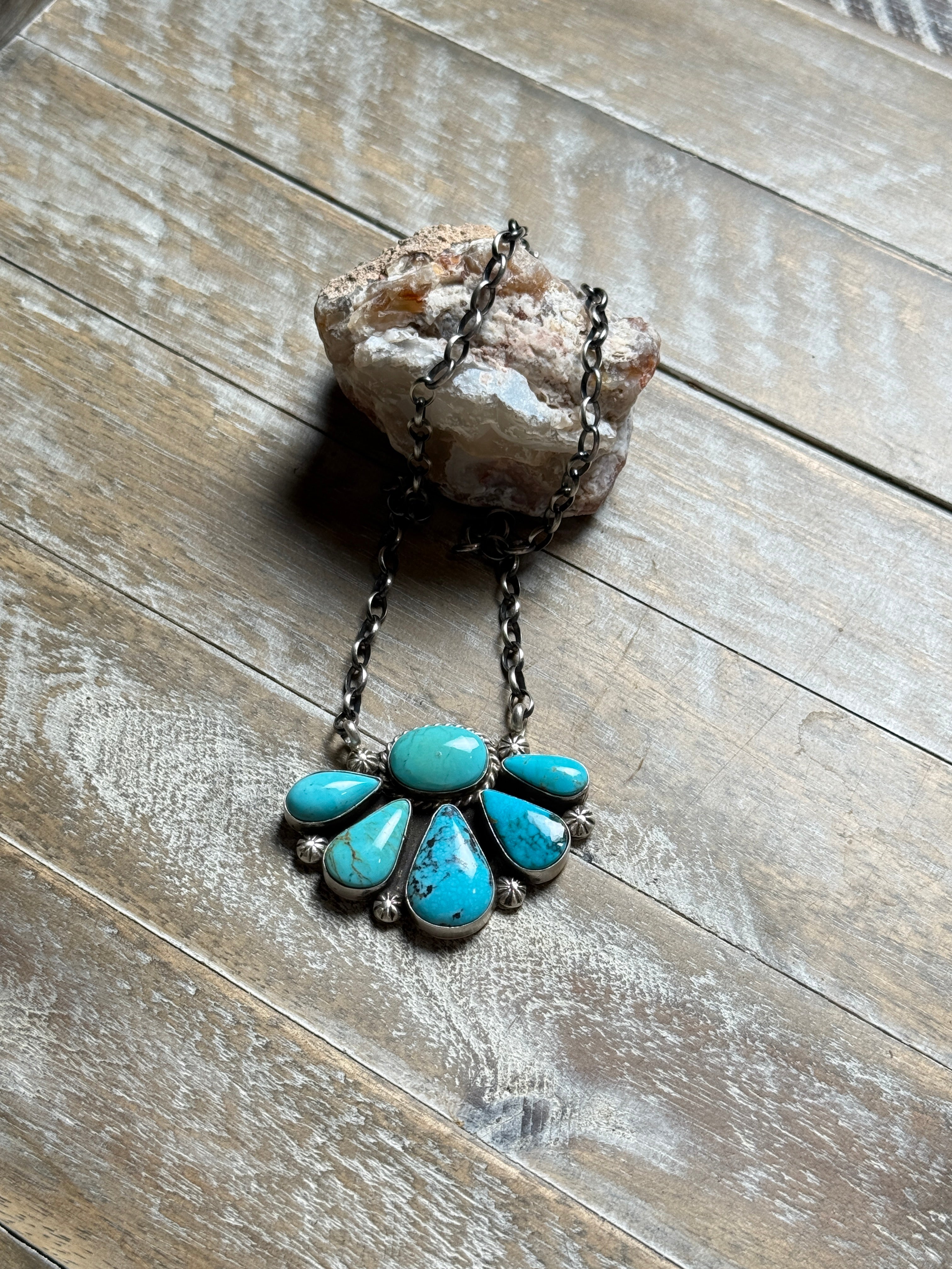 Turquoise stone necklace on a wooden surface