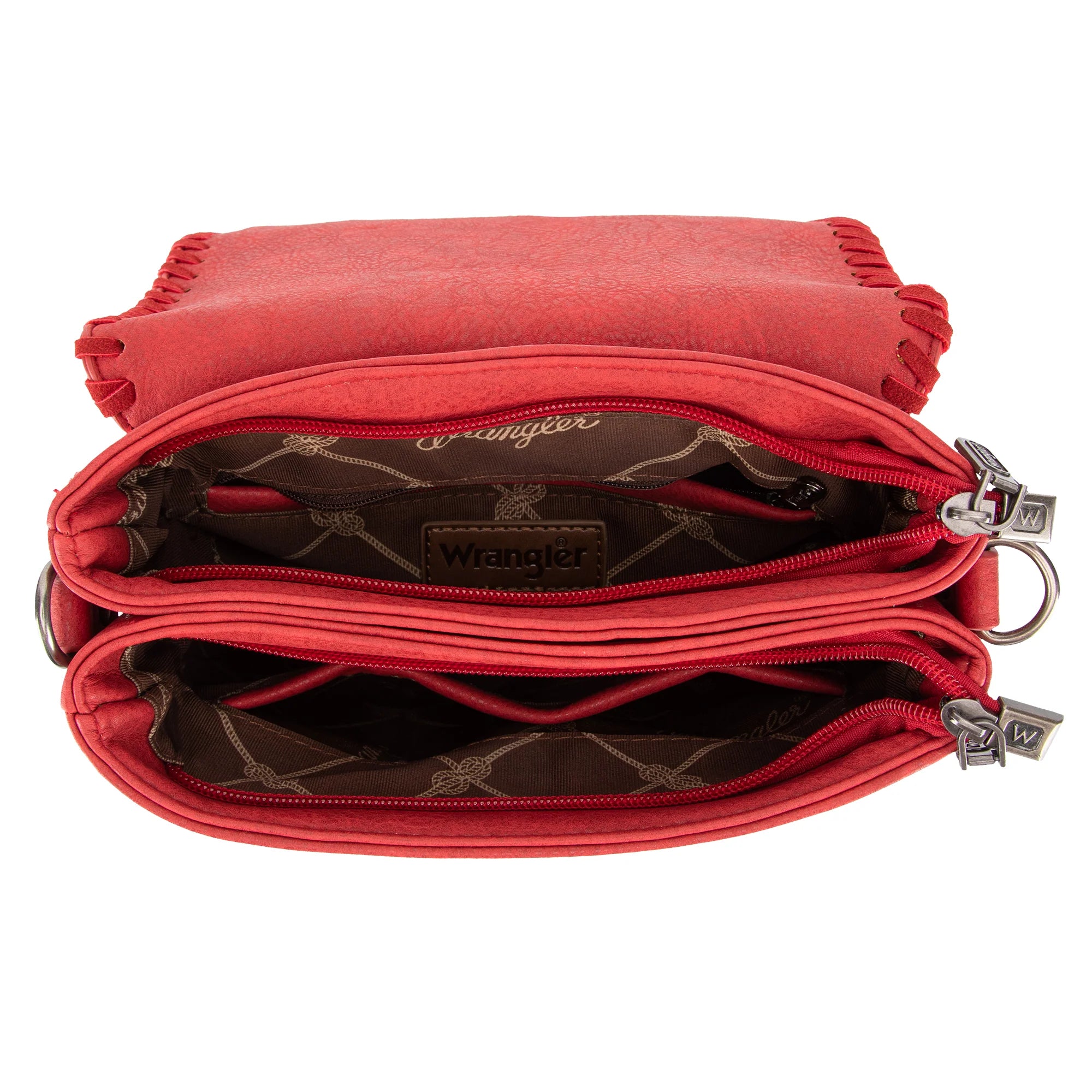 A red crossbody bag with whipstitch detailing and a leopard print adjustable strap, displayed on a mannequin against a leafy background.