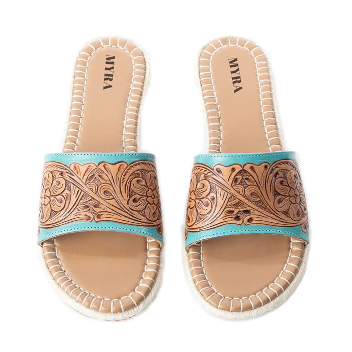 a pair of slides with tooled leather upper and turquoise accents 