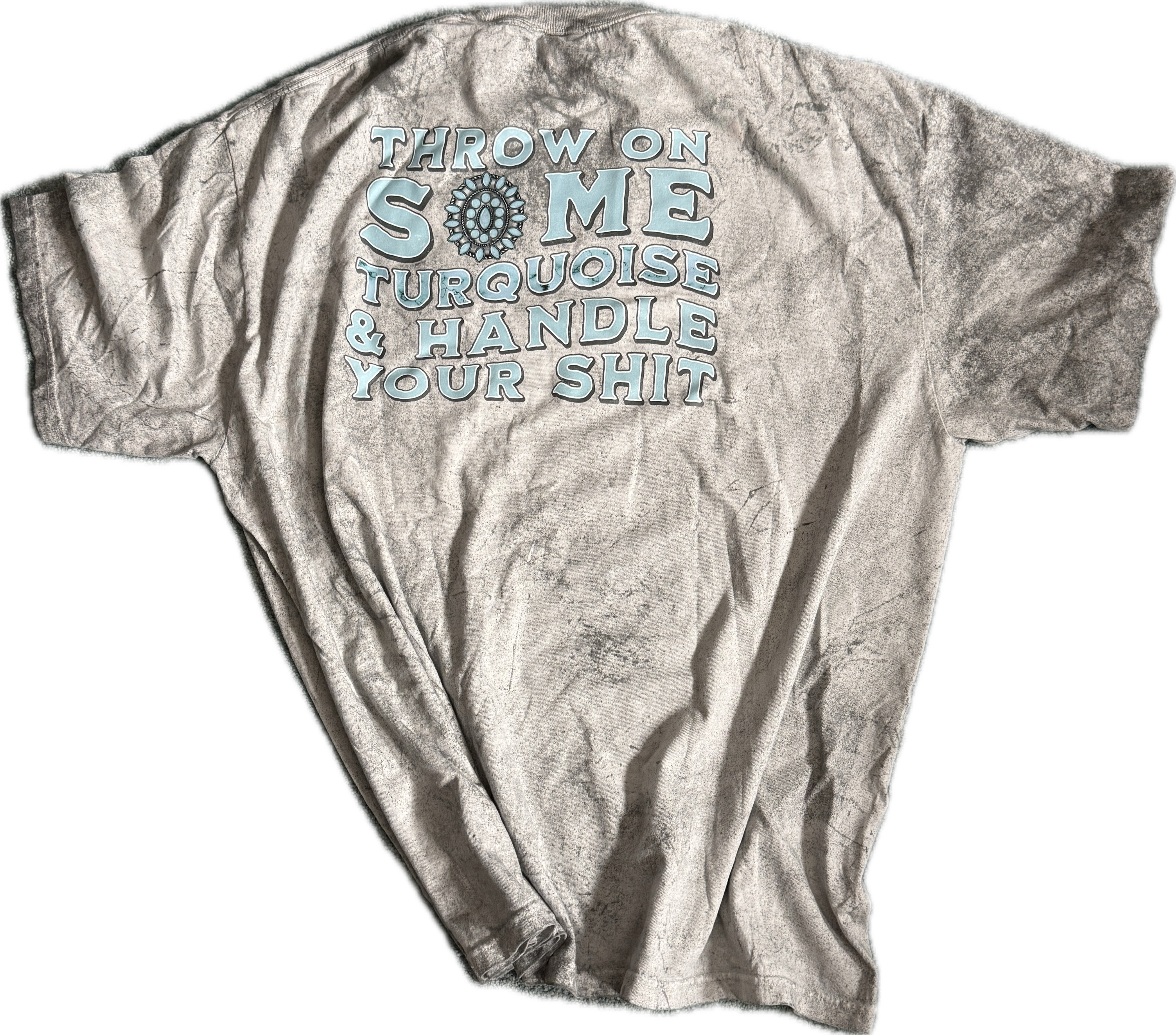 A distressed, acid-wash gray t-shirt with a light blue graphic text print on the back that reads 'THROW ON SOME TURQUOISE & HANDLE YOUR SHIT' next to a turquoise gem illustration.
