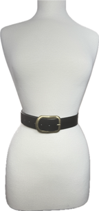 Black belt with a gold buckle on a mannequin against a white background