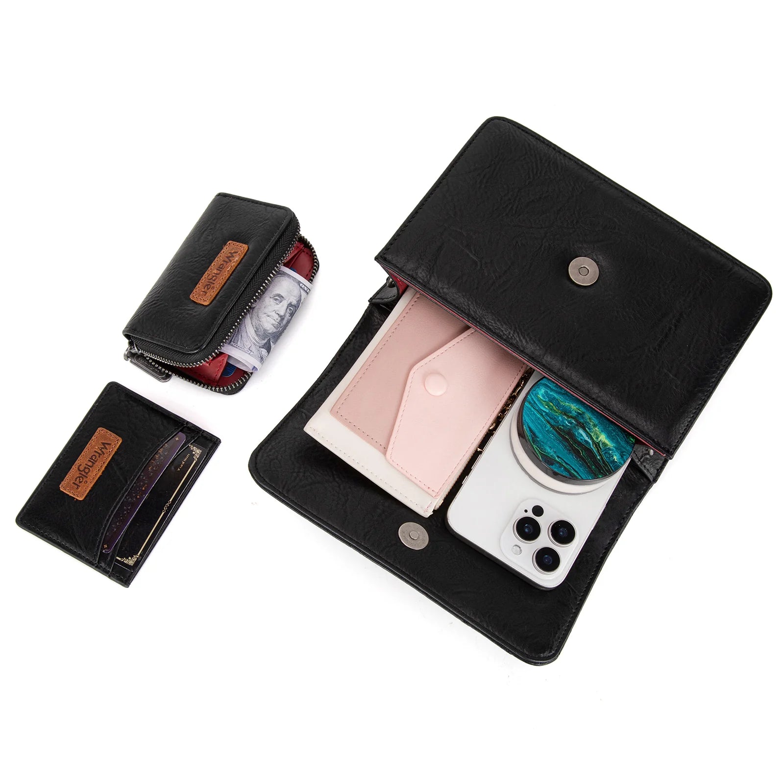 A black 3-piece crossbody bag set by Wrangler, including a mini top handle bag, a wallet, and a card case, each detailed with the iconic Wrangler logo.