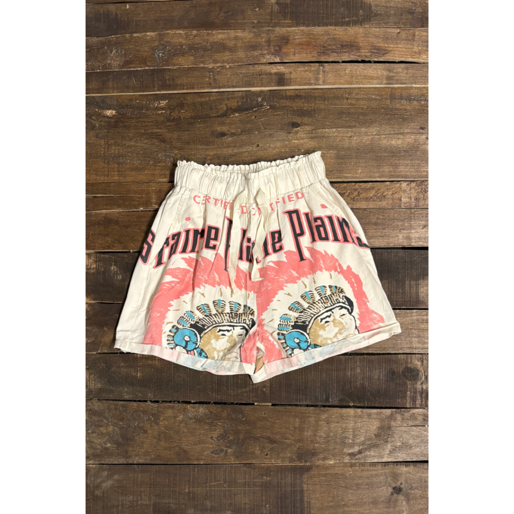 Vintage-style shorts with Native American design on a wooden background