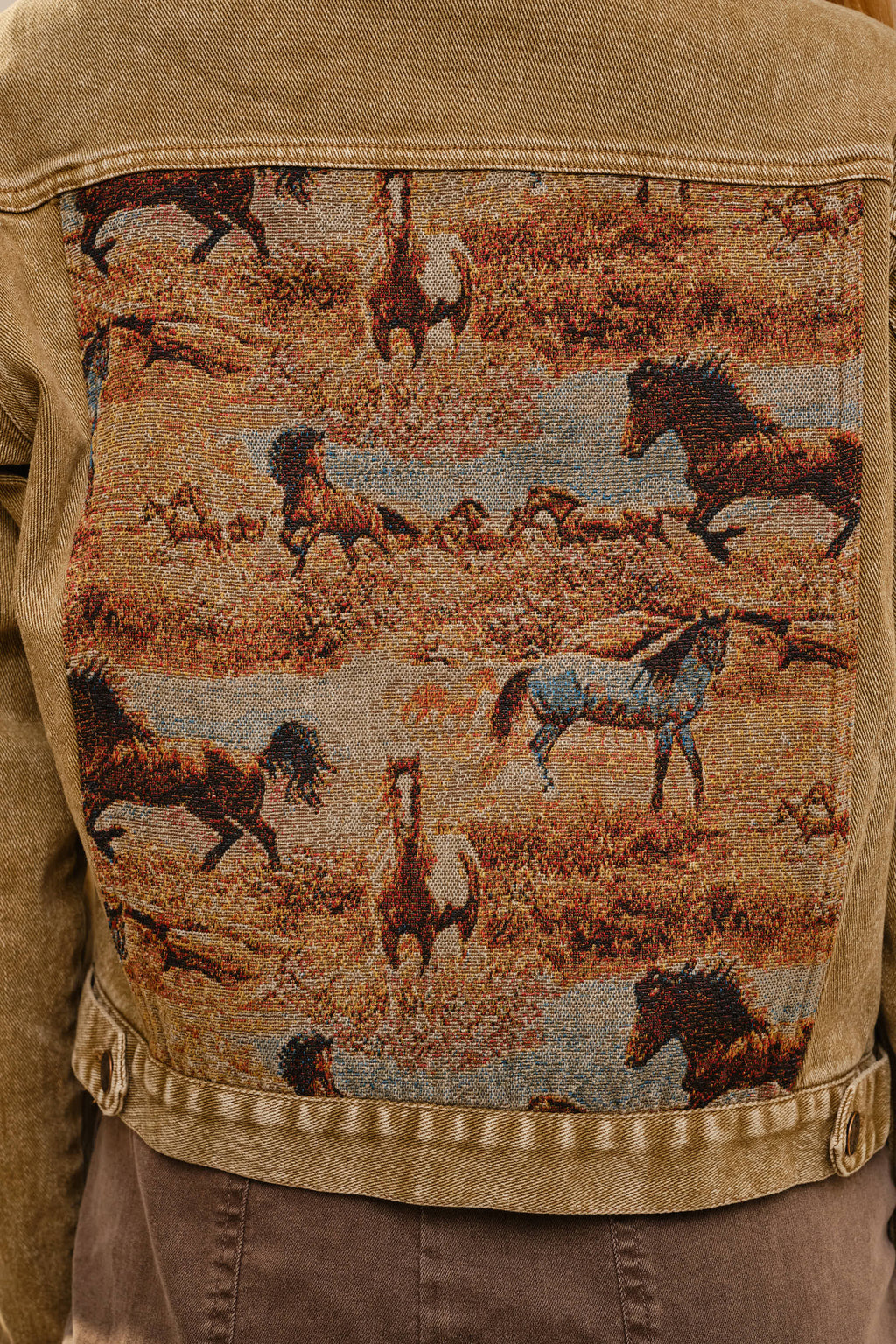 Tan jacket with a tapestry of horses on the back