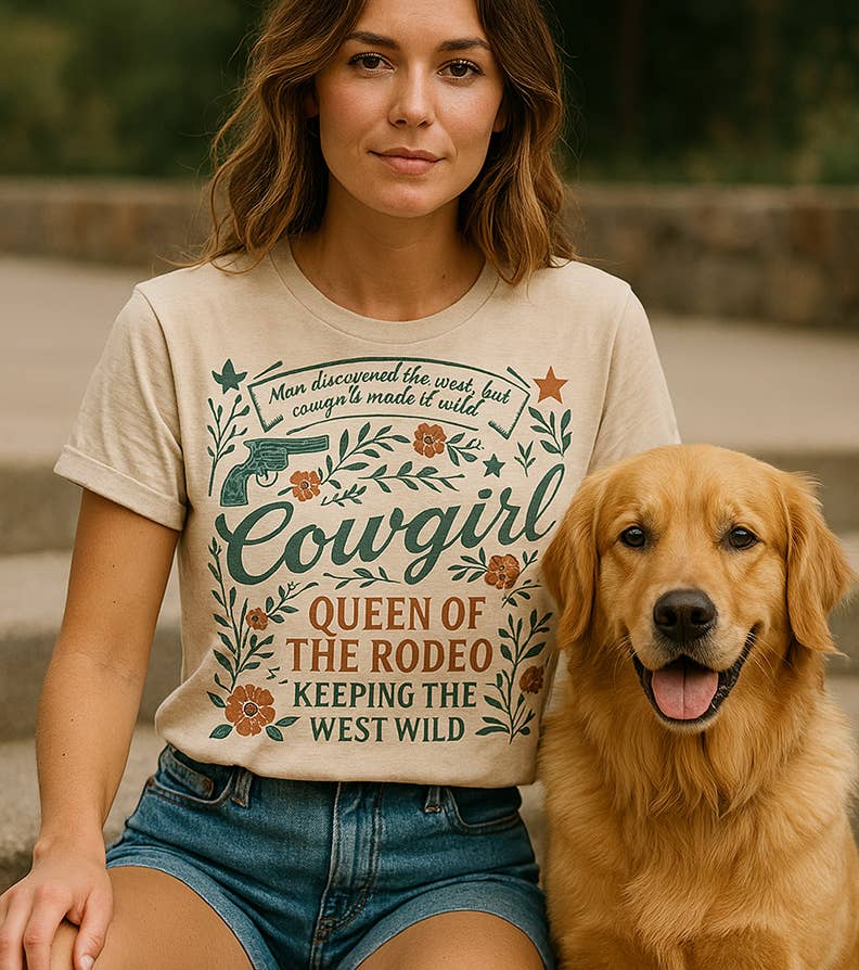 Woman wearing a 'Cowgirl Queen of the Rodeo' t-shirt with a dog sitting next to her.