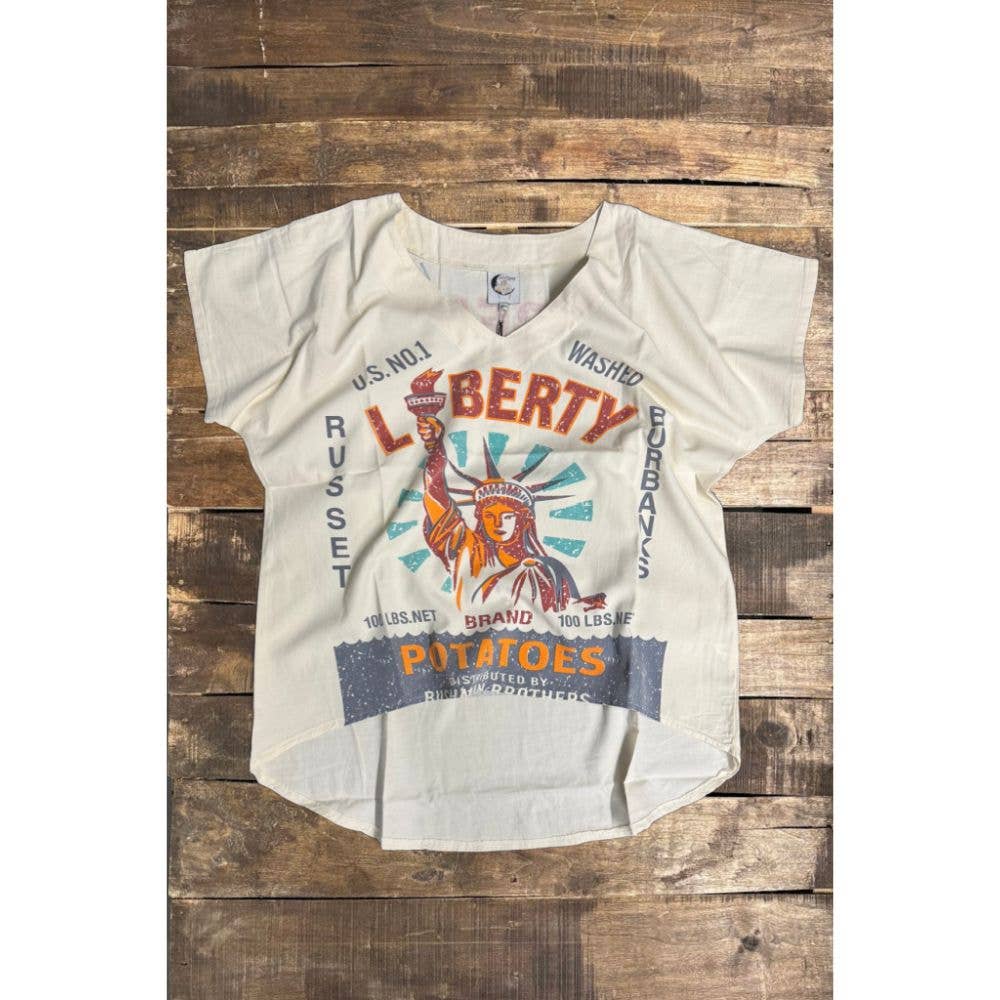 White t-shirt with graphic design on a wooden surface