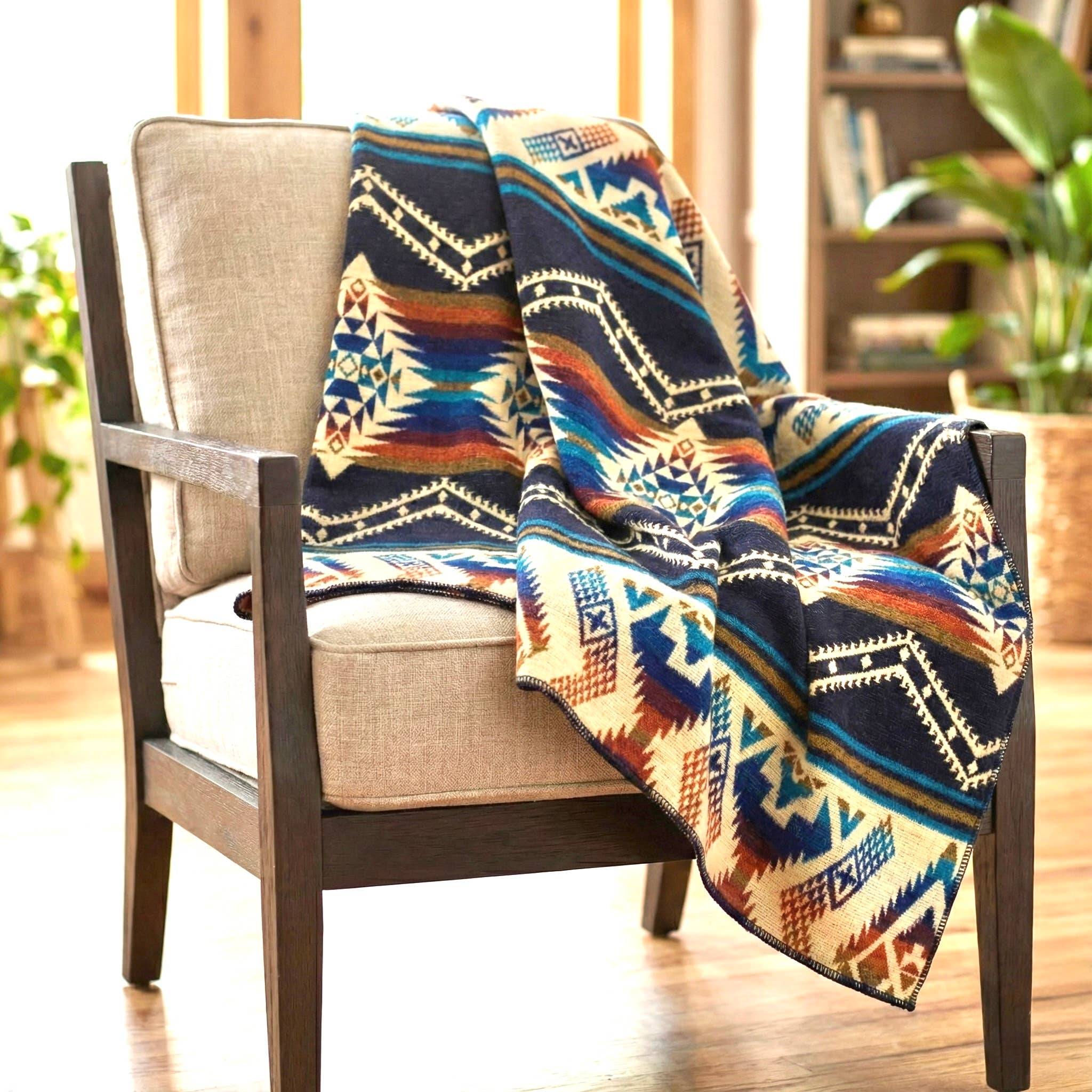 Colorful patterned blanket draped over a chair in a home setting