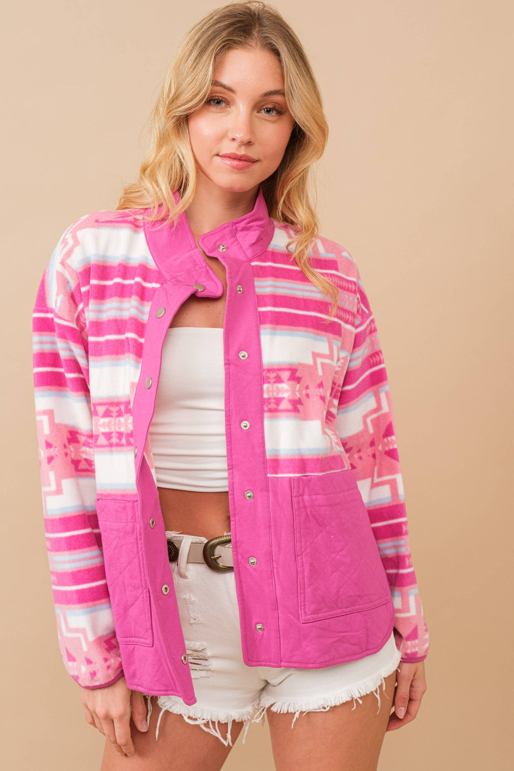 Woman wearing a pink and white striped jacket on a beige background