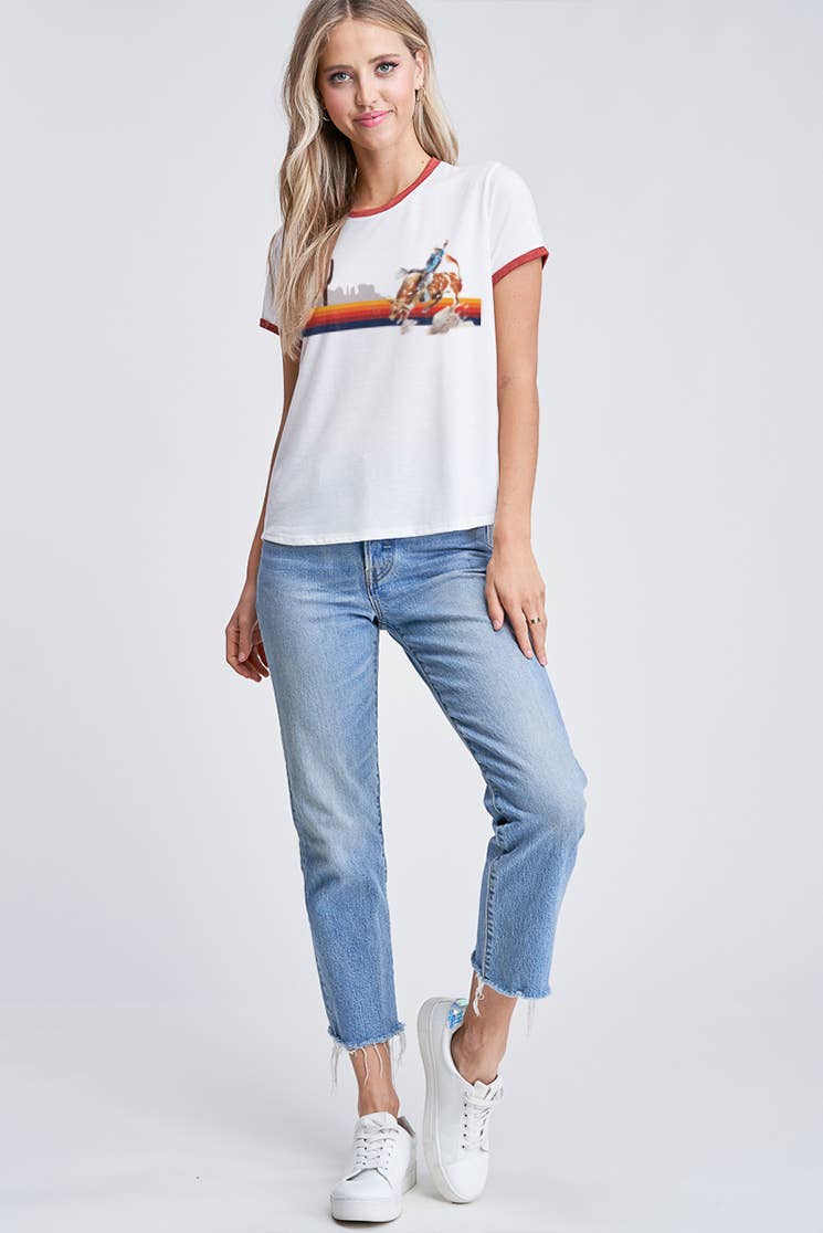Woman wearing a white t-shirt with a graphic design and blue jeans on a white background