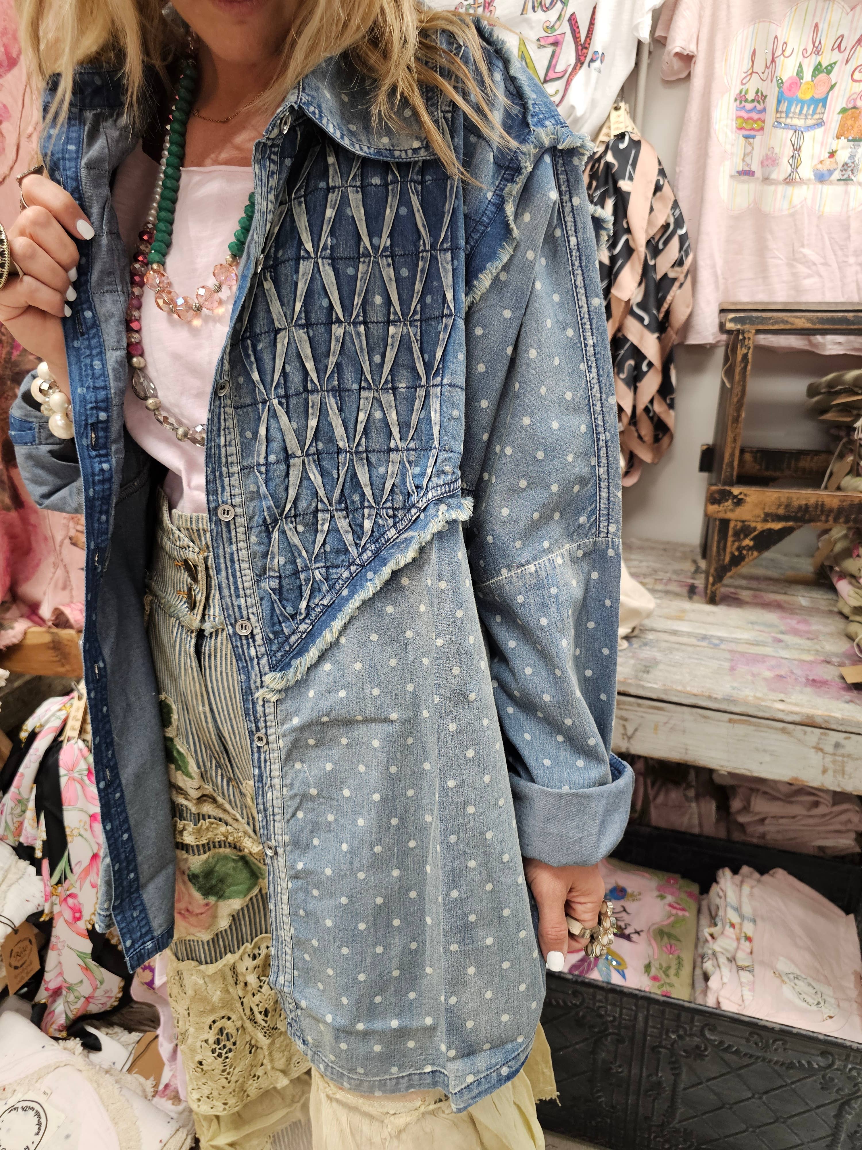 Person wearing a denim jacket with geometric patterns in a store setting