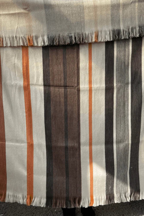 Striped fabric with brown, orange, and gray colors on a plain background